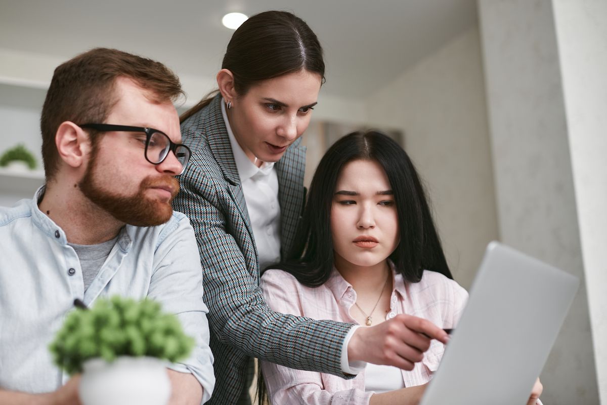 Two colleagues looking over work together