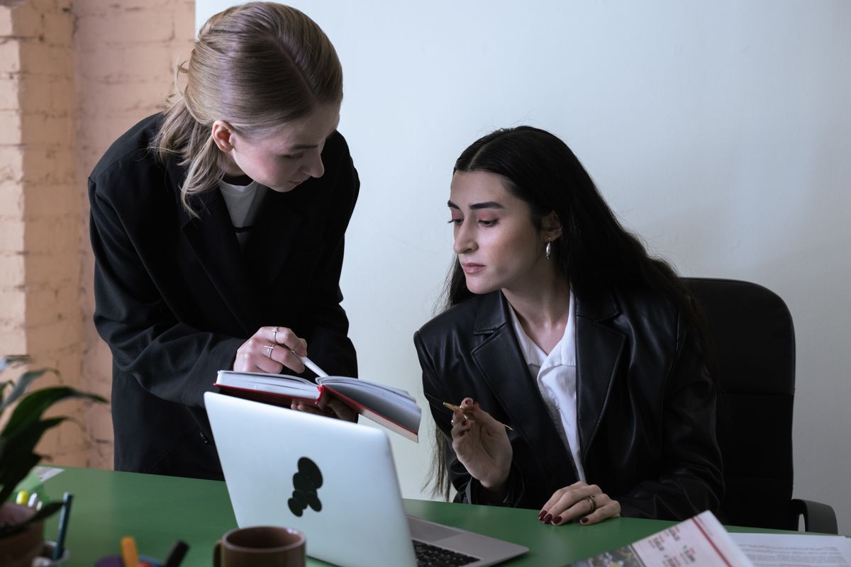 Colleagues working through the day at a desk